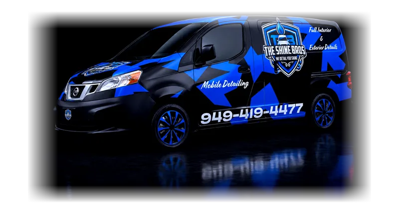 The Shine Bros mobile detailing van — black with an electric blue wrap, lit in a studio.
