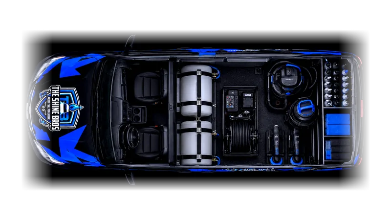 Cutaway plan of The Shine Bros van seen from directly above with the roof removed: the cab at the front, two strapped water tanks behind it, a generator, pressure washer and hose reel in the middle, and an extractor, vacuum, polishers and racked bottles at the back.